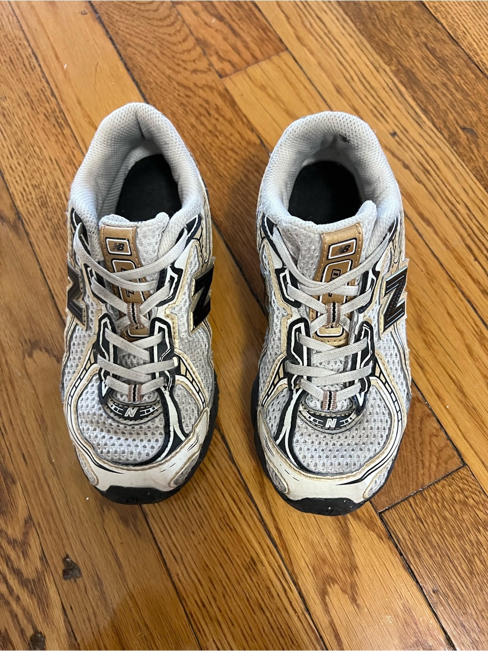 New Balance Kids White and Black Sneakers with Gold Accents